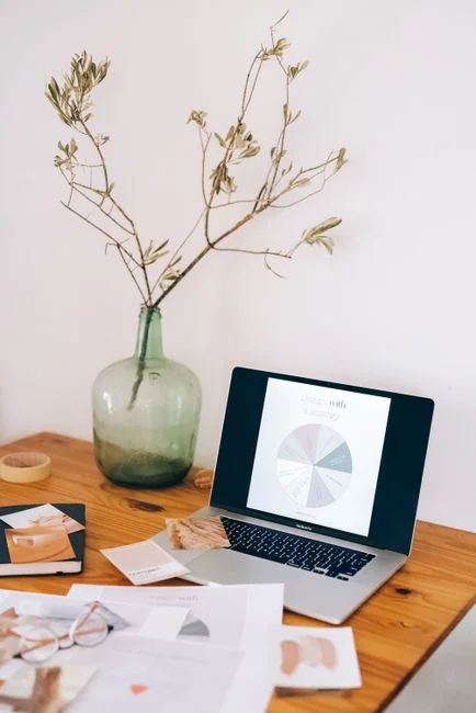 A stylish workspace featuring a laptop and monitors displaying design software.